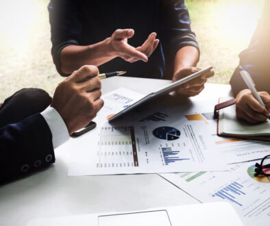 Business people using pen,tablet,notebook are planning a marketing plan to improve the quality of their sales in the future.